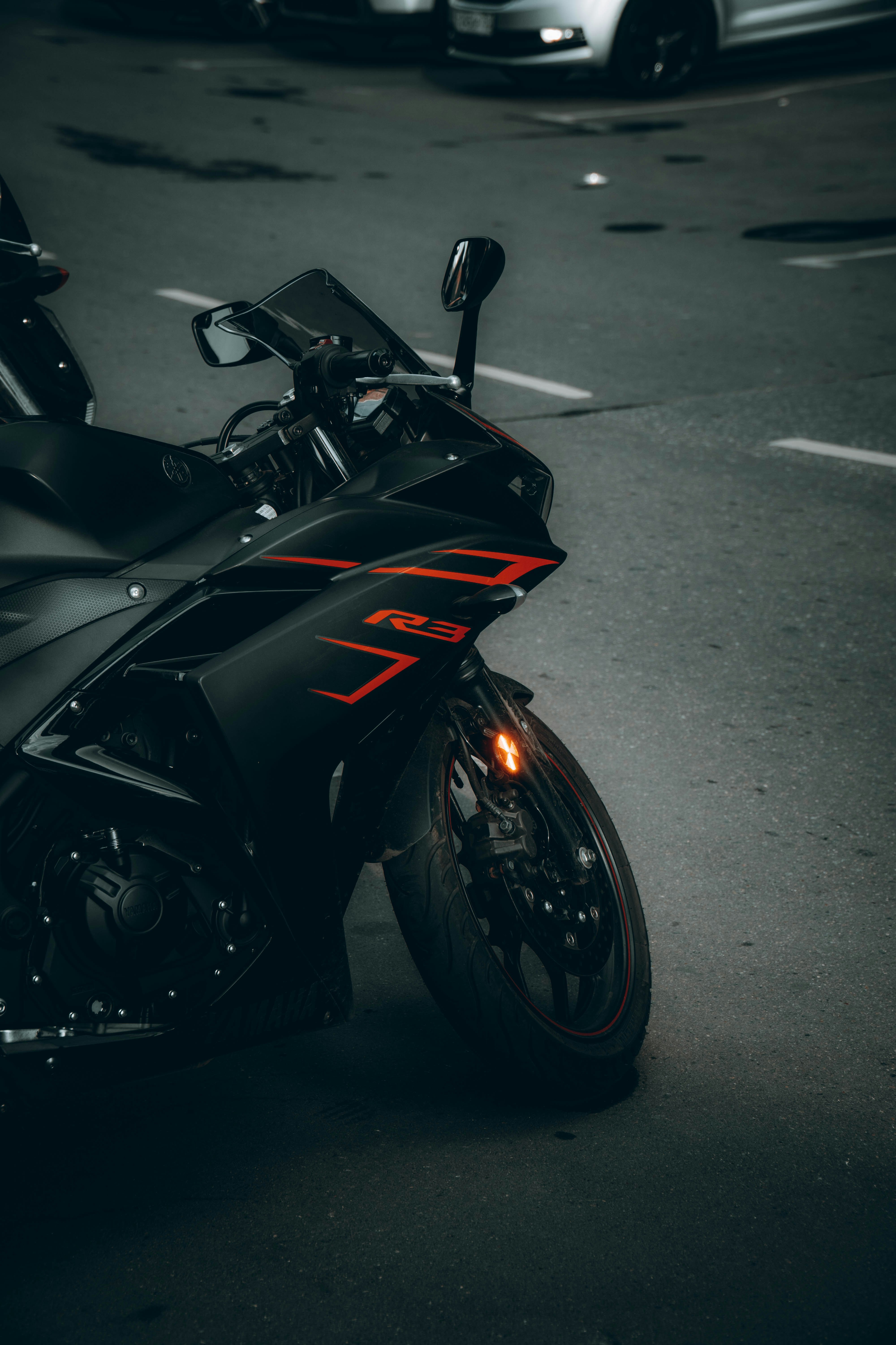 black and red sports bike on gray asphalt road